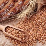 Grain futures lower on stronger dollar and favorable weather
