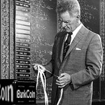 1950s 1960s Stock Broker Reading Quotation Tape At Office Ticker-Tape Machine On Exchange
