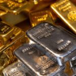 Gold Slips While Silver Retreats From Record as Fed Signals Dovish Tilt