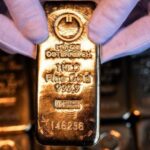Gold Gains Meet Stress as Systematic Selling Looms